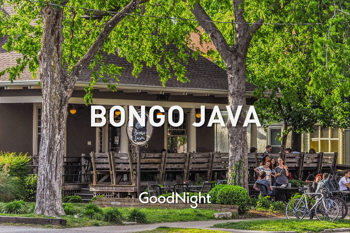 A vibrant exterior view of Bongo Java, featuring outdoor seating with people gathered, bicycles parked out front, and a lively yet relaxed atmosphere. This image captures the sense of community and the enjoyment of relaxing outdoors with coffee or conversation.
